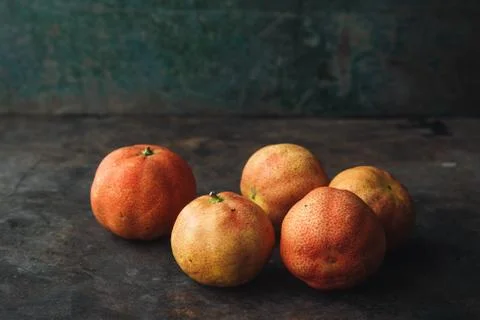 Lemon with rosy pulp on rustic background Stock Photos