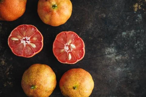 Lemon with rosy pulp on rustic background Stock Photos