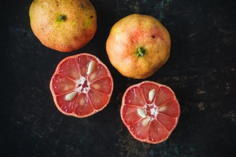 Lemon with rosy pulp on rustic background Stock Photos