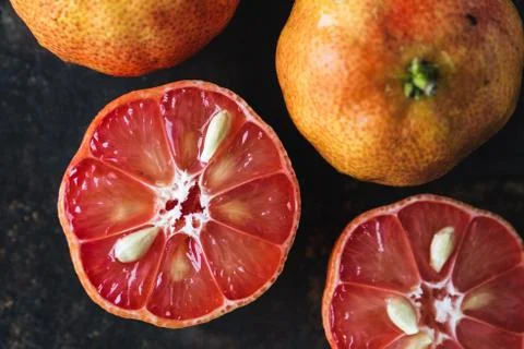 Lemon with rosy pulp on rustic background Stock Photos