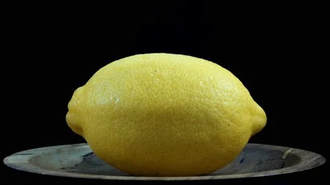 Lemon rotates on a black in 4K Stock Footage 135757856