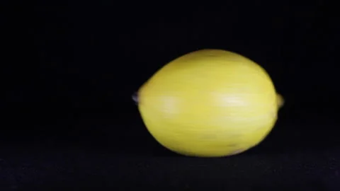 Lemon rotates on a black background Stock Footage 144076340