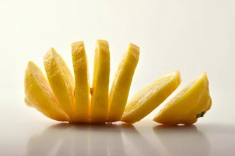 Lemon sectioned on white table Stock Photos