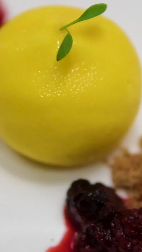 Lemon shaped cake closeup shot of a plate with a lemon shape cake and a fork Stock Footage 302268832