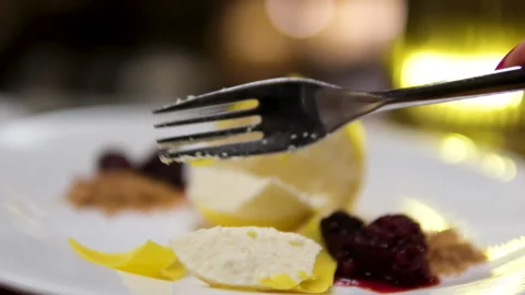 Lemon shaped cake lemon cheesecake Eating slice of lemon cheesecake on plate Stock Footage 302094022
