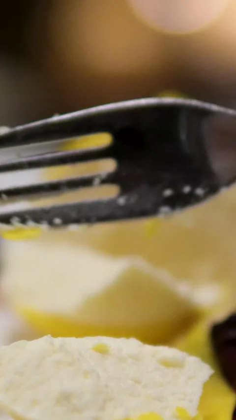 Lemon shaped cake lemon cheesecake Eating slice of lemon cheesecake on plate Stock Footage 302270433