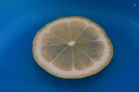 Lemon slice on blue background 스톡 사진