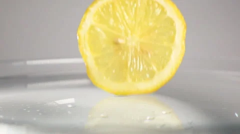 Lemon slice drop down into the water Stock Footage 62917148