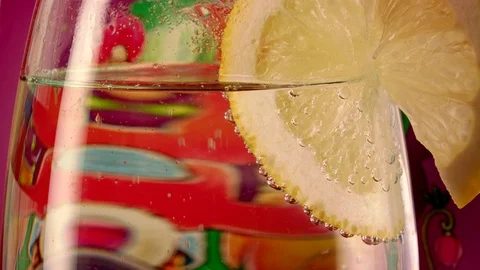 Lemon slice falling in water Stock Footage 87770224