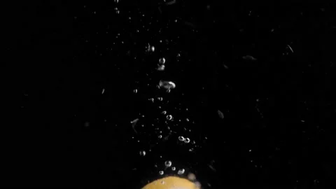 Lemon Slice Falling into Water Super Slowmotion, Black Background, lots of Stock Footage 145729693