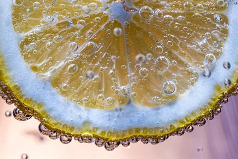Lemon slice floating under water Stock Photos