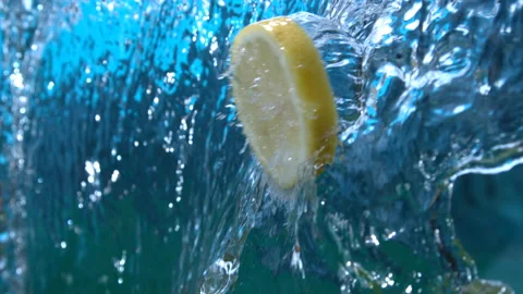 Lemon Slice Flying Through Water Cascade Splashing in slow Motion 4K Video stock 136229976