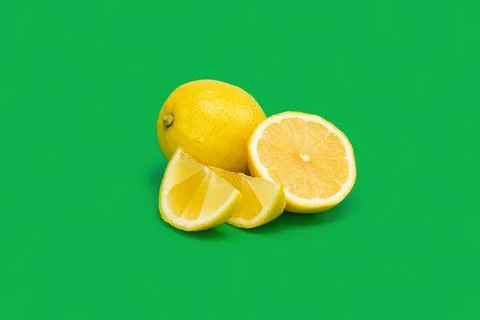 Lemon with slice on green background Stock Photos