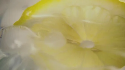 Lemon slice jumps out of the water. Slow mo Stock Footage 75567963