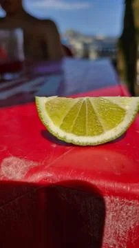 Lemon slice on red table Stock Photos