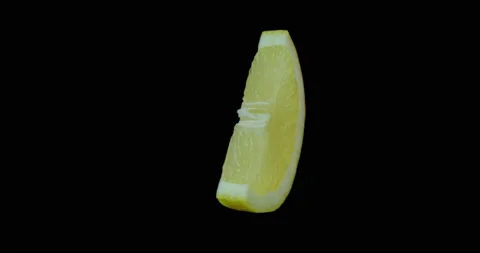 Lemon slice rotating with black background Stock Footage 233569878