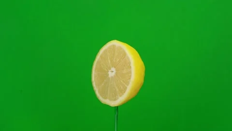 Lemon slice spin on green screen Stock Footage 143518066
