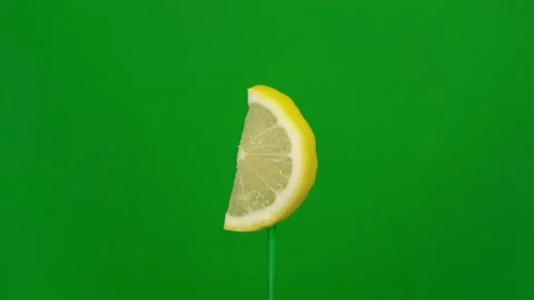 Lemon slice spin on green screen Stock Footage 143535534