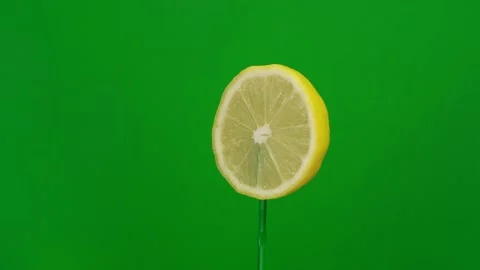 Lemon slice spin on green screen Stock Footage 143536036
