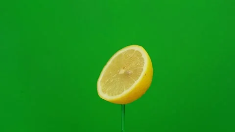 Lemon slice spin on green screen Stock Footage 143554536