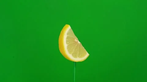 Lemon slice spin on green screen Stock Footage 143554579