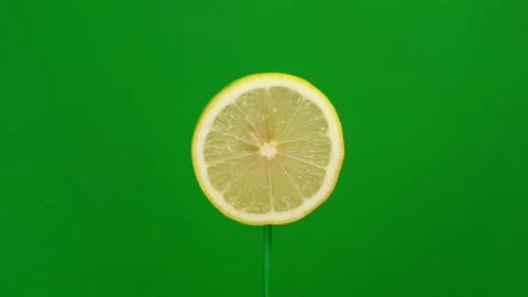 Lemon slice spin on green screen Stock Footage 143554793