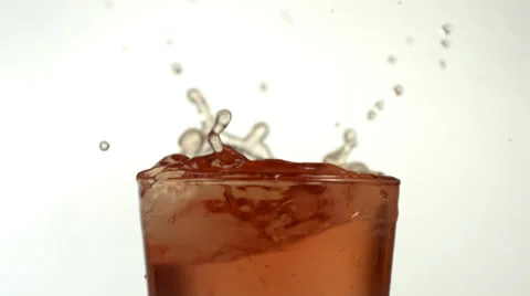 Lemon slice splashing into iced tea, slow motion Stock Footage