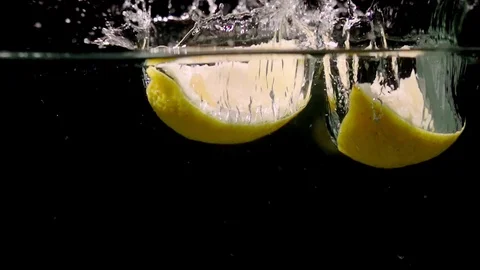  Lemon slice splashing into water on black background closeup super slow motion 動画素材 117006345