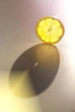 Lemon Slice in the Sunbeams. Background. Copy Space Stock Photos