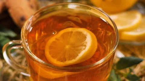 Lemon slice swims in a black tea in glass transparent tea cup, top veiw Stock Footage 103999094