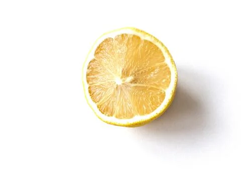 A lemon is sliced in half and the inside is shown Stock Photos