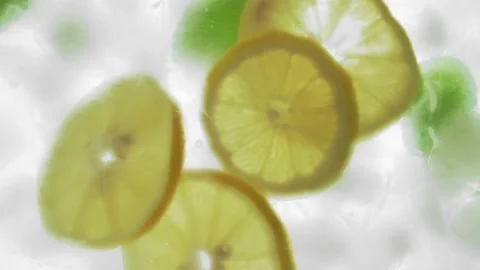 Lemon slices and mint falling into ice water, bottom view. Stock Footage 149193064