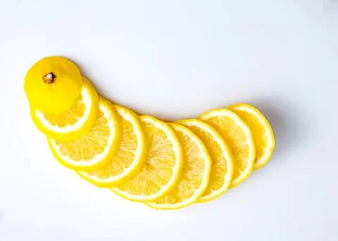 Lemon slices arranged in a curved pattern on white background Stock Photos