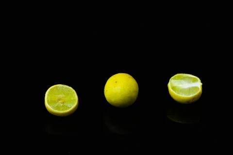Lemon slices on black isolated background Stock Photos