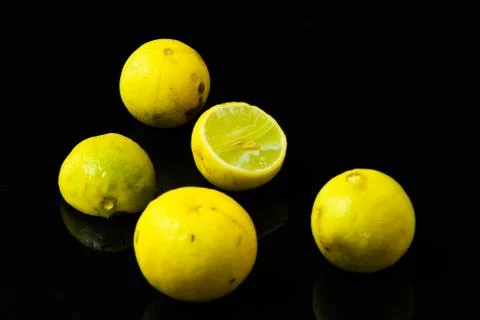 Lemon slices on black isolated background Stock Photos