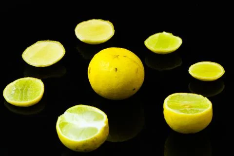 Lemon slices on black isolated background Stock Photos