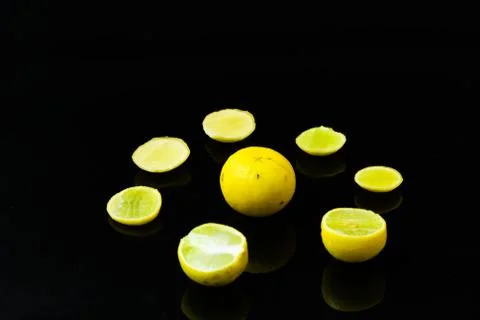 Lemon slices on black isolated background Stock Photos