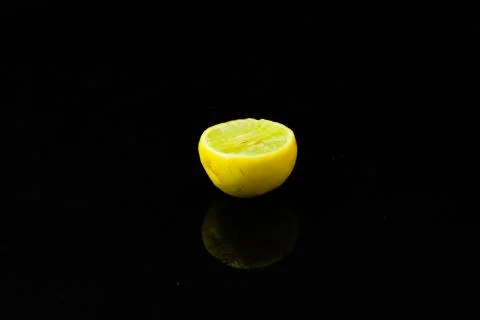 Lemon slices on black isolated background Stock Photos