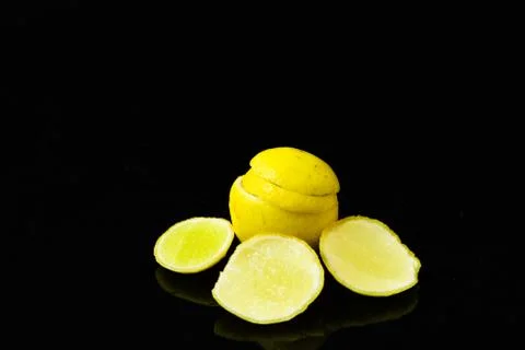 Lemon slices on black isolated background Stock Photos