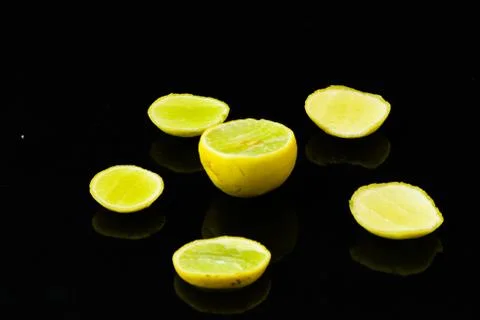 Lemon slices on black isolated background Stock Photos