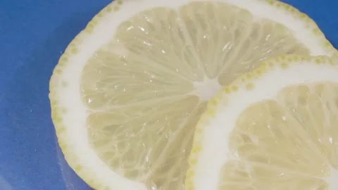Lemon slices close-up. Blue background. 4K video . Citrus fruit. Video stock 140681698