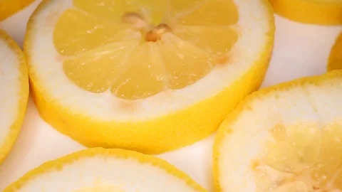 Lemon slices closeup texture video on rolling rotating looping plate Stock Footage 104332725