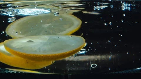 Lemon slices fall into the water Stock Footage 117399231