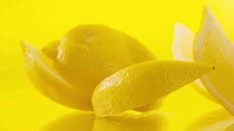Lemon slices fall into the water on yellow background Super slow-mo 1000 fps Stock Footage 276732247