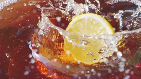 Lemon slices falling and splashing into iced tea Stock Footage 287695225