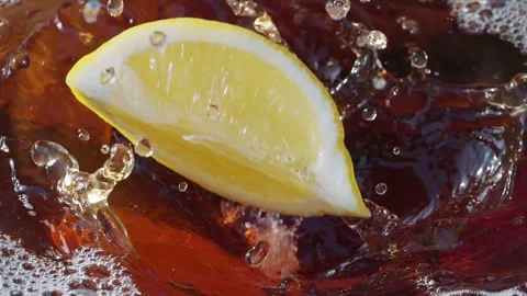 Lemon slices falling and splashing into iced tea Stock Footage 287695711