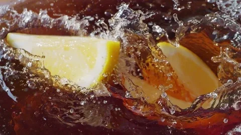 Lemon slices falling and splashing into iced tea Stock Footage 287695762