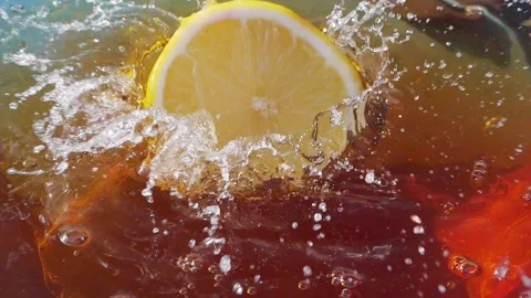 Lemon slices falling and splashing into iced tea Stock Footage 287697042