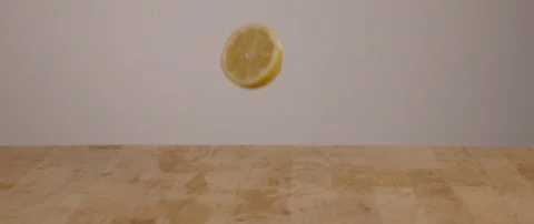 Lemon Slices Falling Onto Cutting Board In Slow Motion 스톡 동영상 105376801