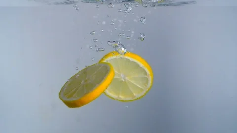 Lemon slices falling into water Stock Footage 78920542
